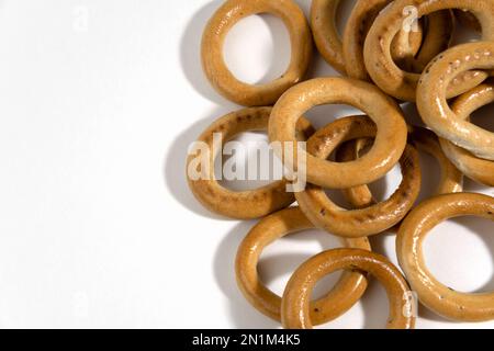 Traditional Russian folk dishes for tea, round or oval drying, isolated on white background. Dried baked bagels. Dessert. Stock Photo
