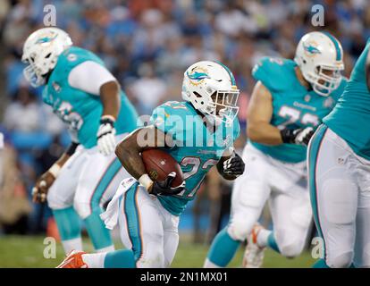 San Francisco 49ers LaMichael James (23) eludes Miami Dolphins