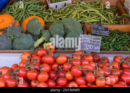 Tomatoes, broccoli and beans for sale at a market Stock Photo
