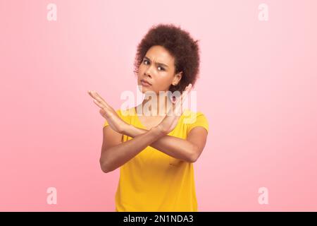 Strict angry millennial multiethnic woman in casual making stop sign with crossed arms Stock Photo