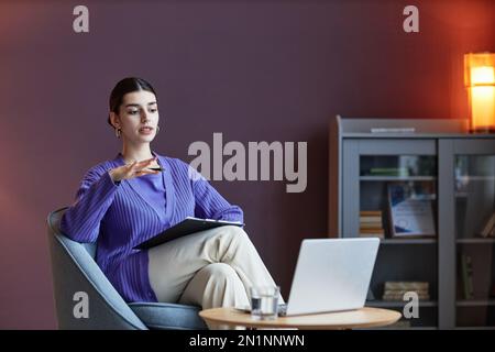 Therapist working in her office, consulting clients online Stock Photo