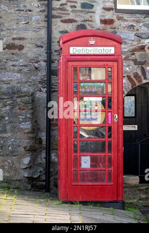 A heart defibrillator for emergency use located in a repurposed K6 telephone box in Dartmouth Devon, UK. Provided by The Community Heartbeat Trust Stock Photo