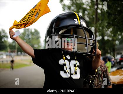 Tom Bowman of Canton, Ohio waves a Terrible Towel as he wears a Pittsburgh  Steelers helmet he made to honor Steelers running back Jerome Bettis, who  was a member of the Pro