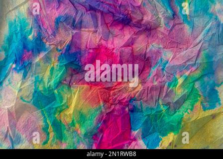 Texture created with napkin paper with multicolored liquid watercolors creating a gradient and rainbow effect Stock Photo