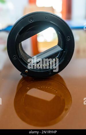 Portrait view of Macro extension tubes on glass background. Two separated extension tubes for macro photography. Stock Photo
