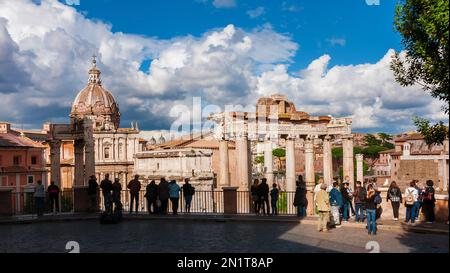 Tourism in Rome. Tourists and visitors taking photos of Roman Forum ancient ruins from Capitoline Hill panoramic terrace Stock Photo