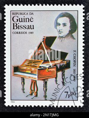 Cancelled postage stamp printed by Guinea Bissau, that shows Piano - F. Chopin, International Year of Music, circa 1985. Stock Photo