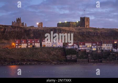 Dusk falls over Whitby harbour and the Church of St. Mary, North Yorkshire, England Stock Photo