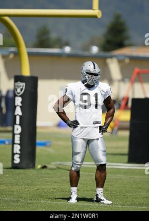 Oakland Raiders defensive end Justin Tuck (91), middle linebacker Miles  Burris (56) and safety Charles Woodson (24) surround Kansas City Chiefs  tight end Travis Kelce (87) as he picks up a first