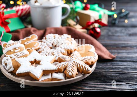 Delicious Christmas cookies on black wooden table table Stock Photo
