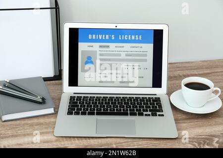 Laptop with driver's license application form on table in office Stock Photo