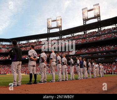 members of the St. Louis Cardinals stand for the National Anthem in their  1982 blue uniforms before a game against the Milwaukee Brewers at Busch  Stadium in St. Louis on August 5