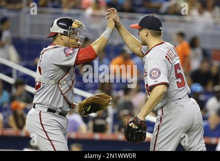 Washington Nationals closing pitcher Jonathan Papelbon (58) high-fives  right fielder Bryce Harper (34) after a baseball game against the Miami  Marlins, Thursday, July 30, 2015, in Miami. The Nationals defeated the  Marlins