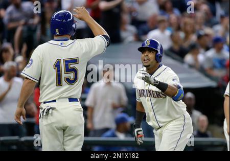 Seattle Mariners' Nelson Cruz is greeted in the dugout after he hit a  three-run home run in the first inning of a baseball game against the New  York Mets, Sunday, July 30