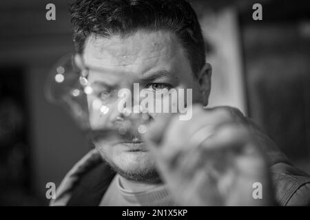 Man sampling Scottish Whisky at Holyrood distillery in Edinburgh, Scotland Stock Photo