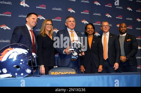 From left to right, Damani Leech, the new president of the Denver Broncos,  joins his daughters, Brianna and Simone, and wife Tamara for a photo after  an introductory news conference at the