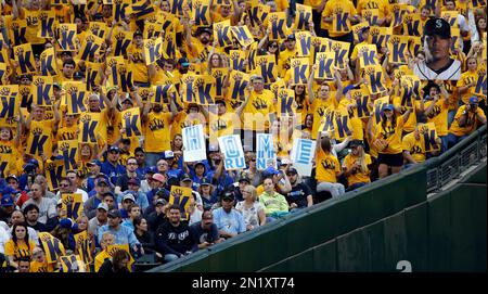 Seattle Mariners fans sit near a sign, based on the popular Wordle