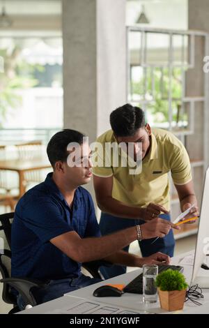 Team of UX designers discussing project details Stock Photo