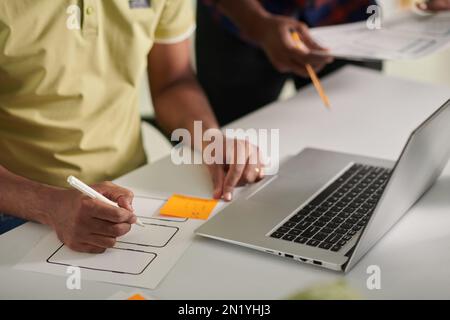 UX designer creating wireframe for new mobile application Stock Photo