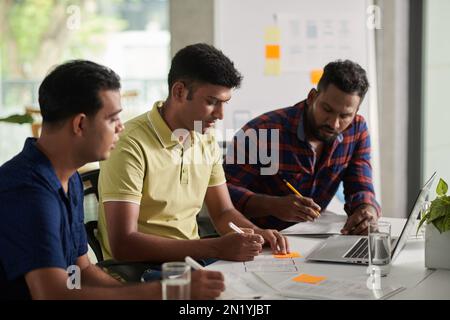 Team of developers working on prototype of new mobile application Stock Photo