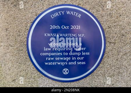 January 28th, 2023. Staines, Surrey, England, UK. Activists from Staines Extinction Rebellion (XR) joined a UK-wide day of action. They installed 2 blue plaques on Staines bridge over the river Thames to shine a light on local Spelthorne conservative MP, Kwasi Kwarteng, who on 20th October 2021 voted to block amendment 45 to the Environment Act 2021. The amendment would have required water companies to 'demonstrate improvements in the sewage systems and progressive reductions in the harm caused by untreated sewage discharges.' The climate and ecological activists want the government and water Stock Photo