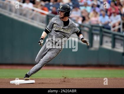 June 24, 2015: After fielding a ground ball, Vanderbilt shortstop Dansby  Swanson #7 underhands the ball to teammate 2nd baseman Tyler Campbell #2 to  turn the double-play in action during game 3