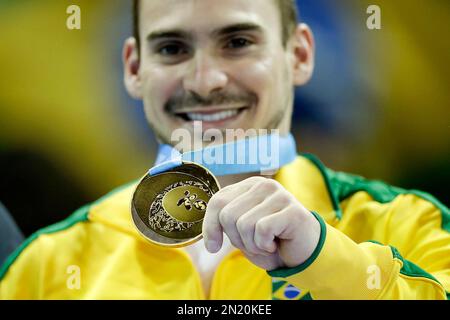 Brazil's Arthur Zannetti holds his gold medal during medals ceremony for the artistic gymnastics rings competition in the Pan Am Games in Toronto, Tuesday, July 14, 2015. (AP Photo/Gregory Bull)