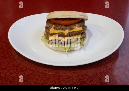 Middle East dishe culinary Still Life. Triple Cheese burger with chopped steak, cheddar cheese, vegetable and salad Stock Photo