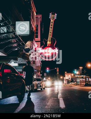 A vertical shot of the illuminated Hard Rock Cafe sign from the street Stock Photo