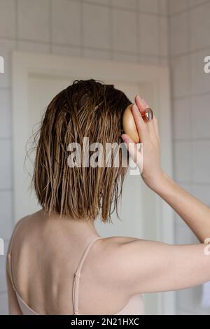 Woman makes a head self massage for hair growth Stock Photo - Alamy