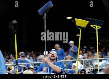 Kansas City Royals fans hold up pictures of starting pitcher Johnny Cueto  and catcher Salvador Perez as he Royals face the New York Mets in game 2 of  the World Series at