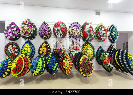 Interior of shop with funeral accessories. Shop selling coffins, funeral wreaths and flowers. Stock Photo