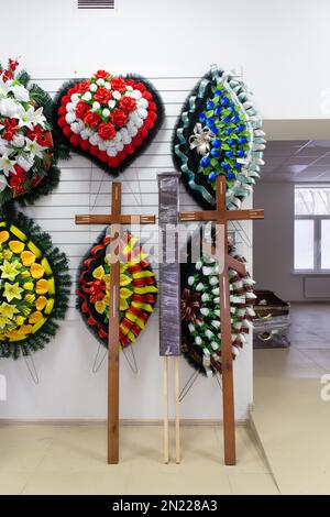 Interior of shop with funeral accessories. Shop selling coffins, funeral wreaths and flowers. Stock Photo