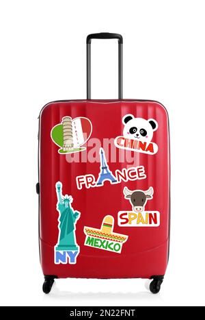 Modern suitcase with travel stickers on white background Stock Photo