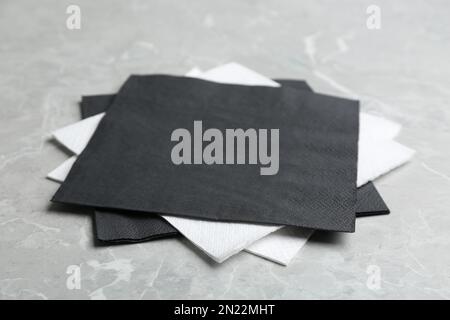 Clean napkins on grey marble table, closeup. Personal hygiene Stock Photo