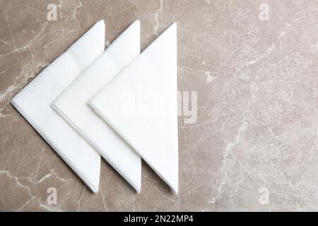 Clean napkins on marble table, flat lay. Space for text Stock Photo