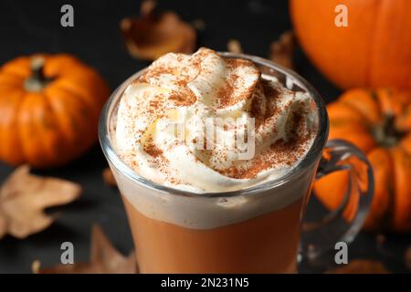 Delicious pumpkin latte with whipped cream on table, closeup Stock Photo