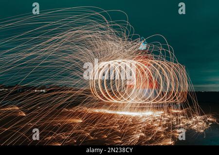 Abstract steel wool photography. The image is taken by lighting steel wool on fire, spinning the fire and walking while taking a long exposure photo w Stock Photo