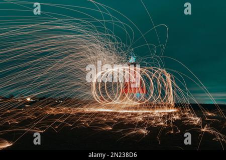 Abstract steel wool photography. The image is taken by lighting steel wool on fire, spinning the fire and walking while taking a long exposure photo w Stock Photo