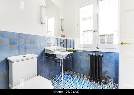 Bathroom decorated in vintage style with beautiful porcelain, marble and chrome metal sink Stock Photo