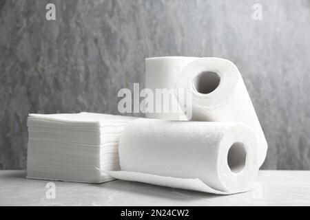 Rolls of paper towels and napkins on marble table Stock Photo