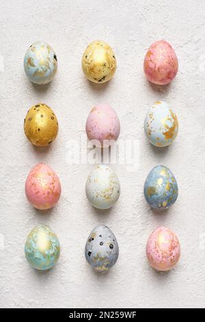 Chic pastel Easter eggs with gold on white background. Flat lay geometric pattern. Happy Easter card. Stock Photo