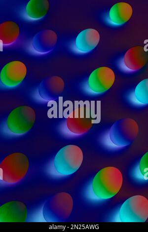 Abstract Easter eggs. Creative pattern with neon colors. Cosmic or disco style background. Trendy holographic effect. Stock Photo