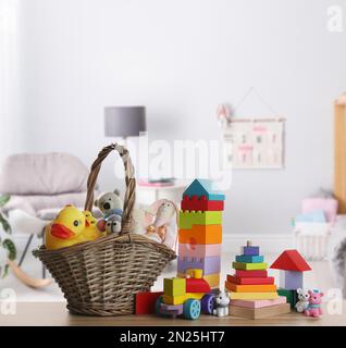 Set of different cute toys on wooden table in children's room Stock Photo