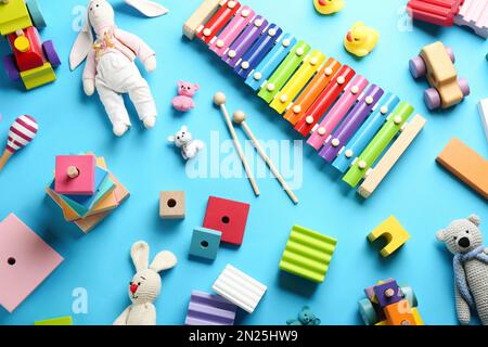 Flat lay composition with different toys on light blue background Stock Photo