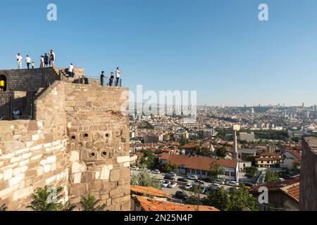 Ankara travel. Tourists on the Ankara Castle with a scenic view of the capital of Turkey. Fortification was constructed in 7th century Stock Photo