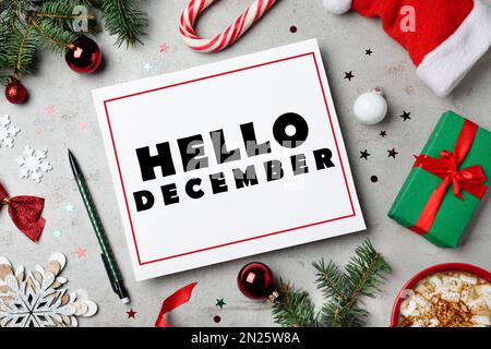 https://l450v.alamy.com/450v/2n25w8a/hello-december-greeting-card-flat-lay-composition-with-christmas-decor-on-grey-background-2n25w8a.jpg