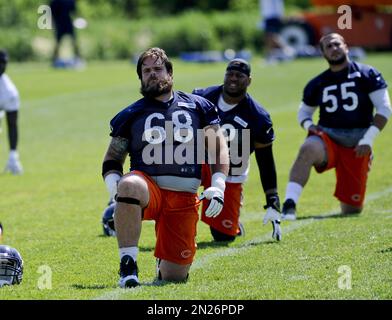 Chicago Bears guard Matt Slauson (68), center, works with defensive tackle  Jeremiah Ratliff (90), left, and defensive end Jared Allen (69) during NFL  football training camp at Olivet Nazarene University, Wednesday, July