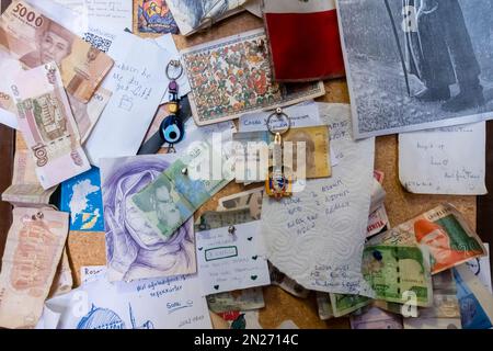 Pinned notes wishes, money, banknote, banknotes, messages on a wall of a hostel Stock Photo