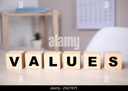 Cubes with word VALUES on wooden table Stock Photo